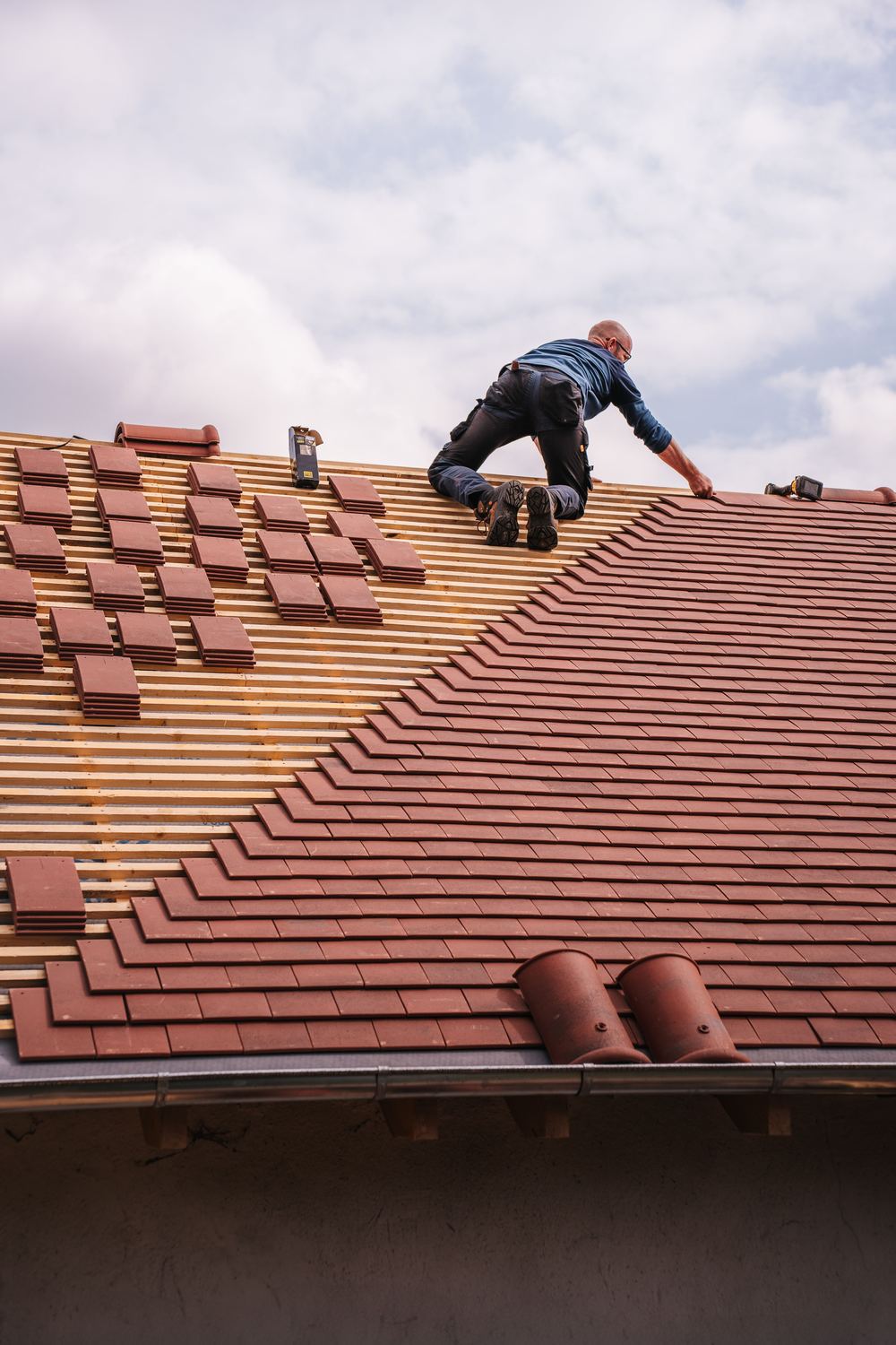 Roofer installing shingles